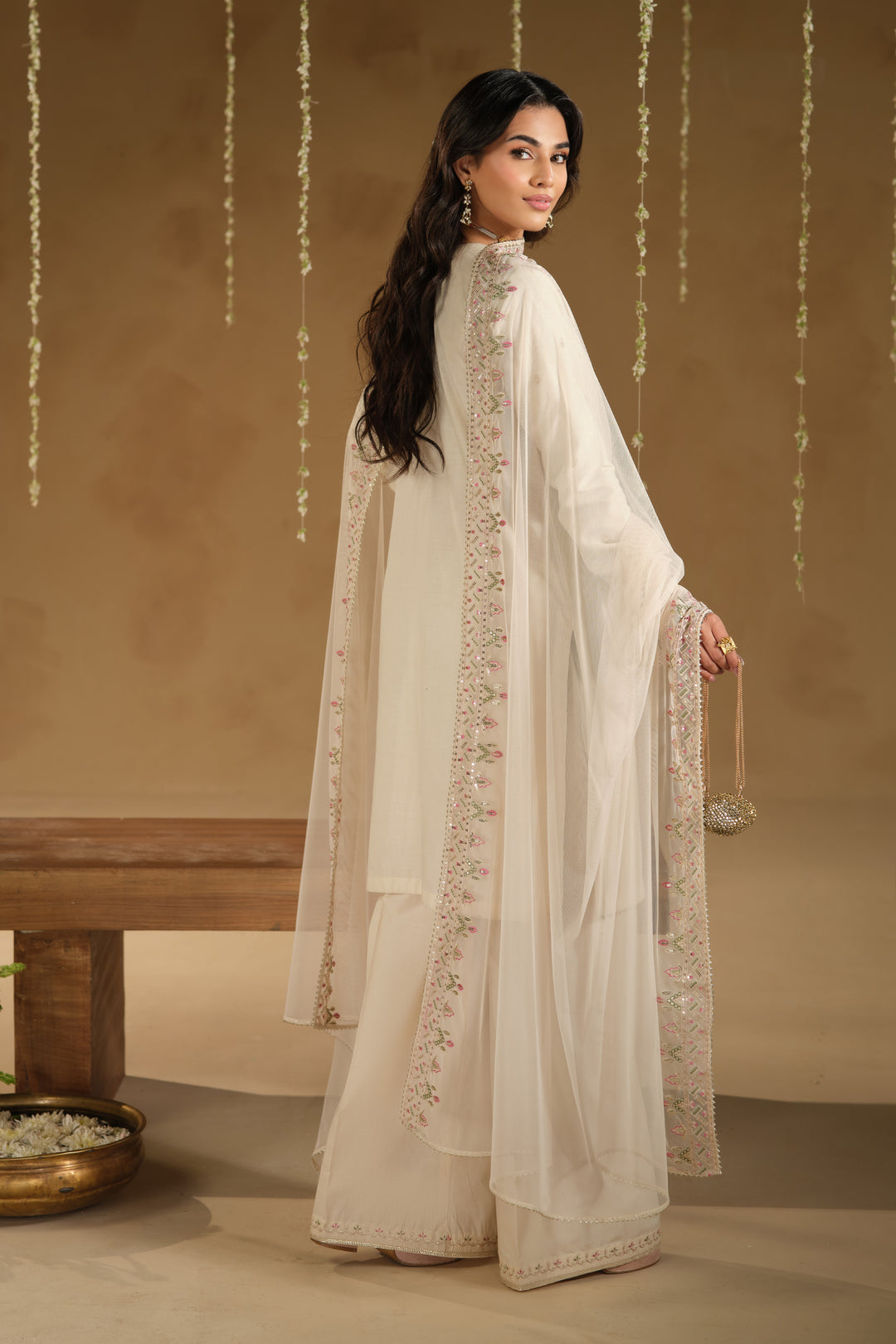 Back view of Rafza 3 piece Eid dress featuring plain straight shirt fall and embroidered bordered net dupatta drape