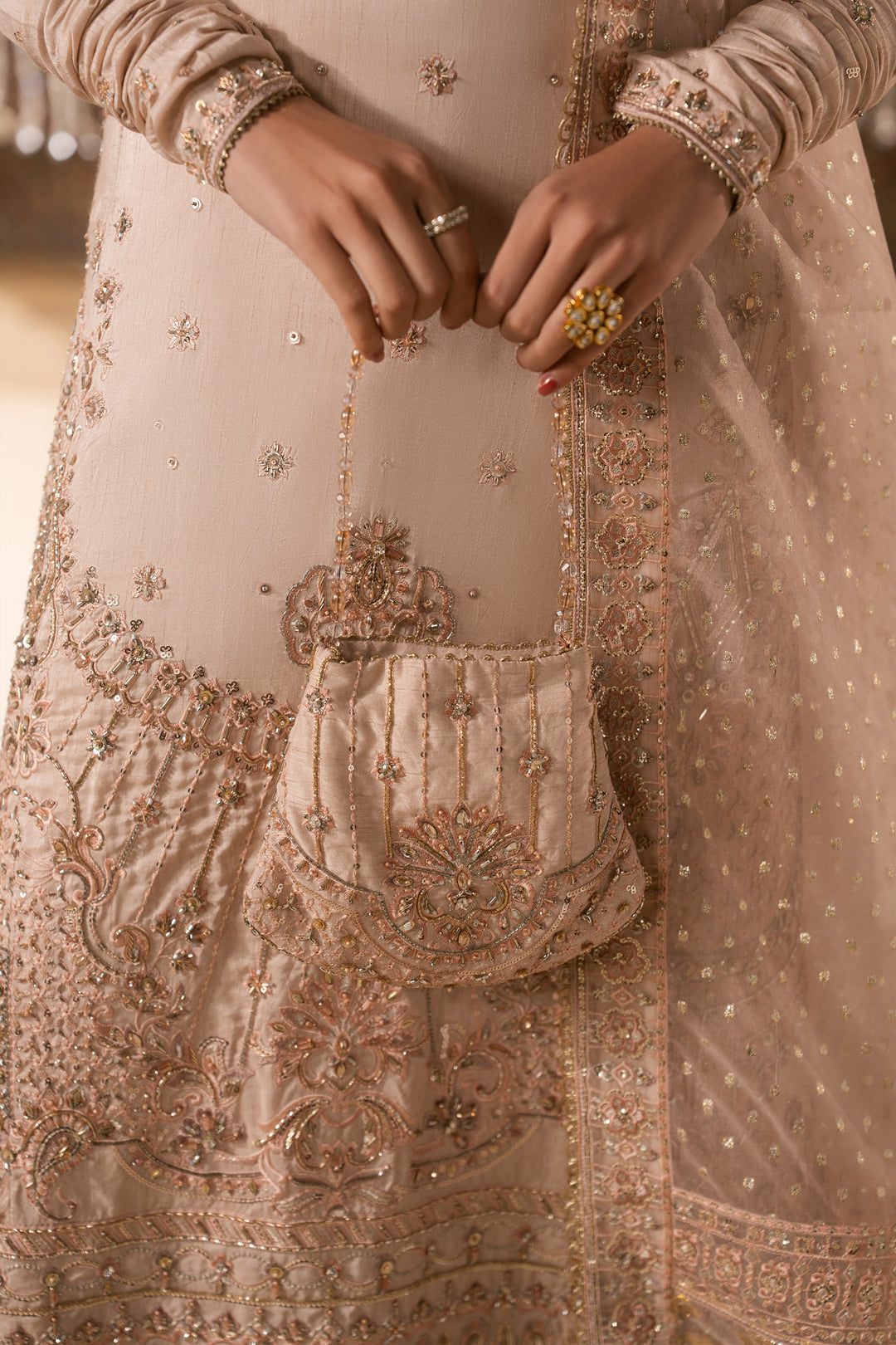 Close up detail of Mahbeer embroidery and matching pouch in pale pink tone, neat stitching formal Nikkah wear for women.