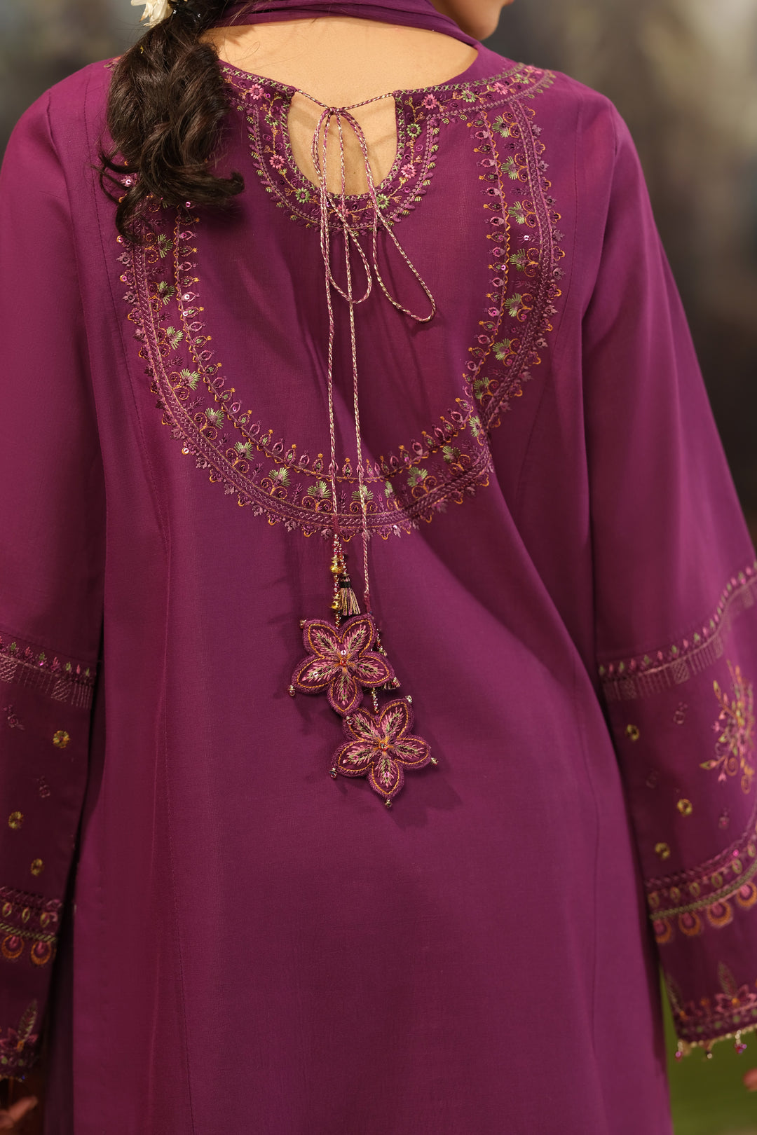 Close view of NAQSHI Huram plum Pima lawn shirt showing round embroidered neckline and vertical front panel embroidery