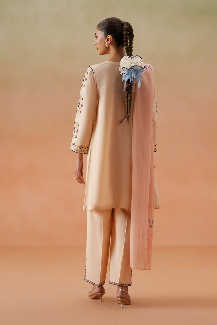 Back view of Faye light peach 3-piece outfit with flowing lawn shirt, printed crinkle chiffon dupatta, and stitched culotte trouser.