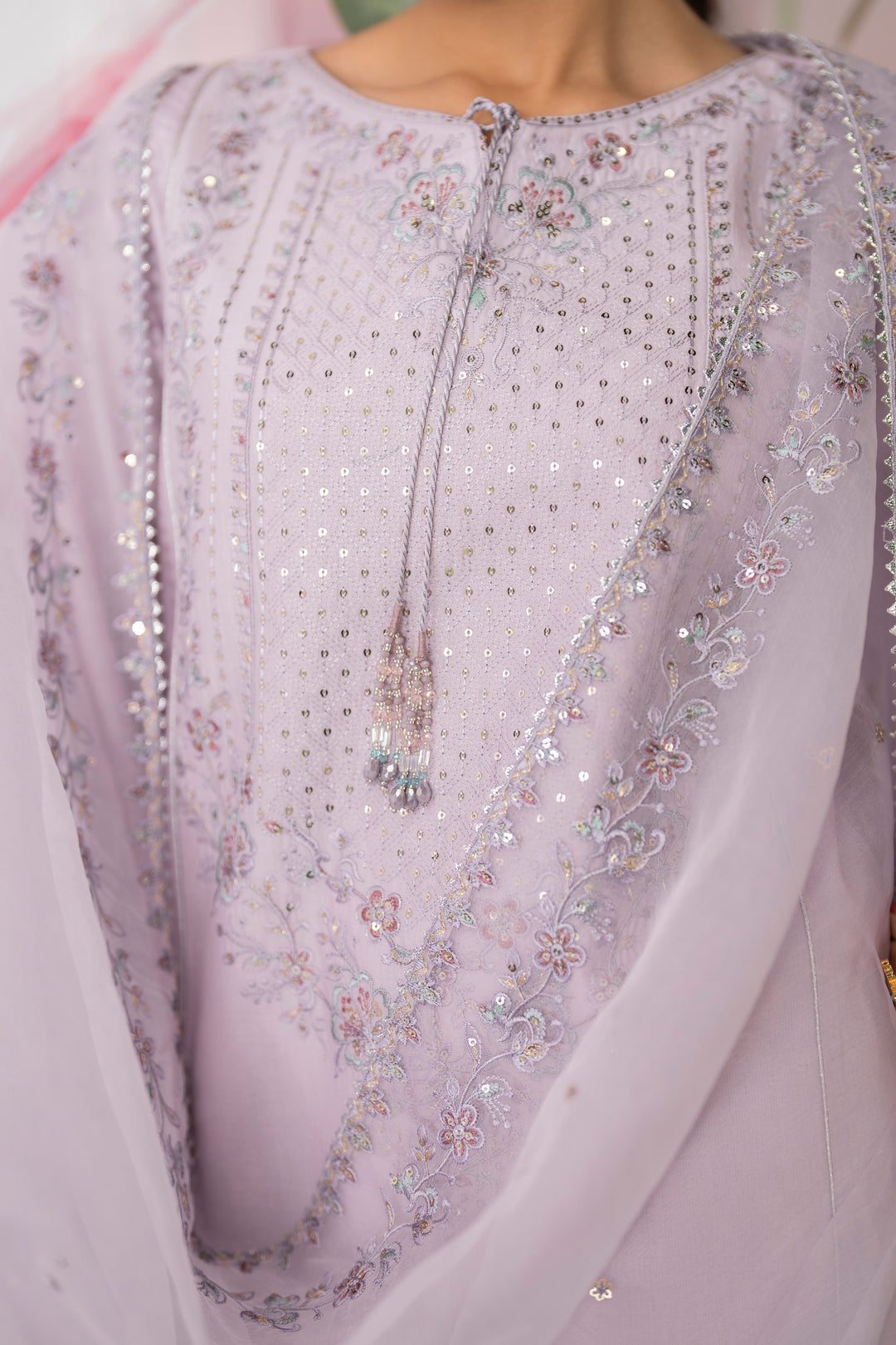 Close up of embroidered neckline with tassels and detailed thread work on dipa lavender pima lawn shirt