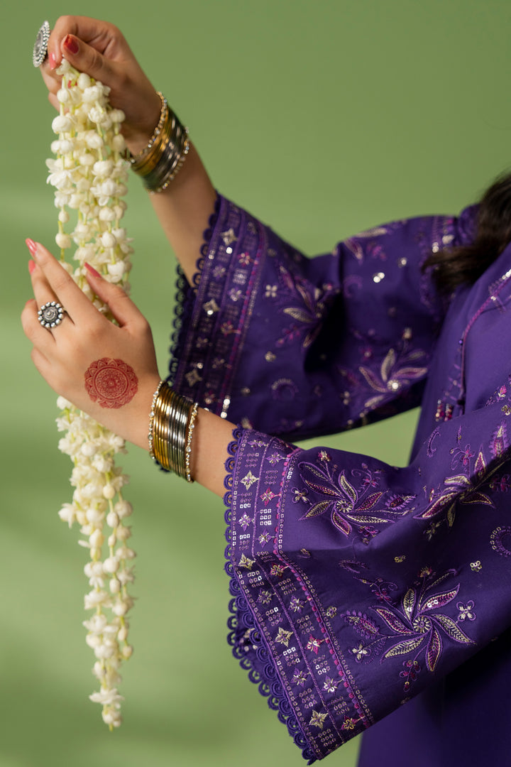Close-up of NAQSHI Uzma sleeve showing full embroidery detail on purple fabric