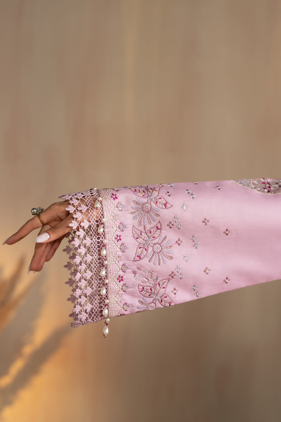 Sleeve close up showing embroidered cuff border and lace finishing of Shayleigh suit, detailed summer ready to wear outfit.