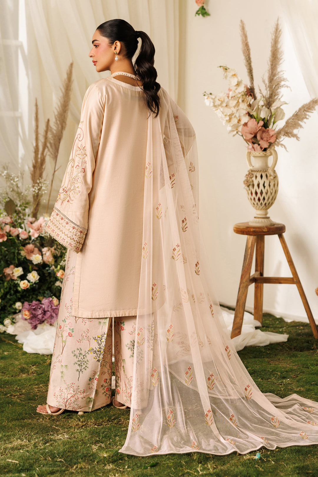 Back view of NAQSHI Rayla outfit showing relaxed shirt cut and light net dupatta drape