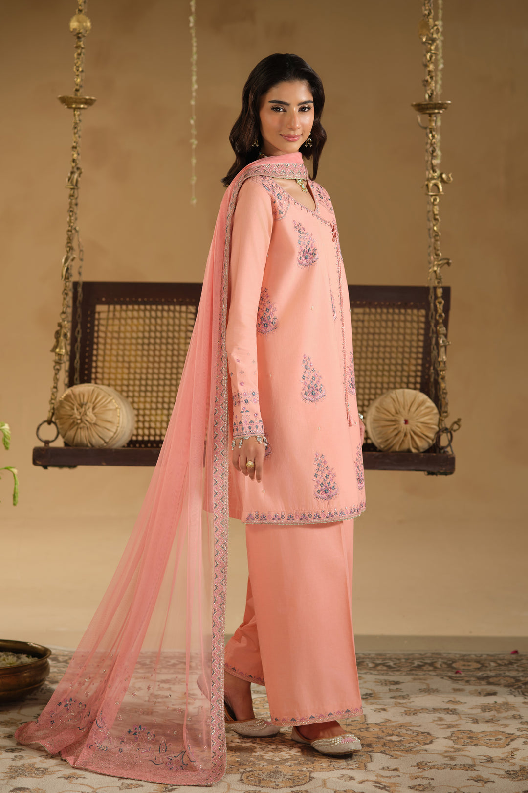 Side angle of Umaiza ready to wear outfit with flowing net dupatta and embroidered sleeve borders
