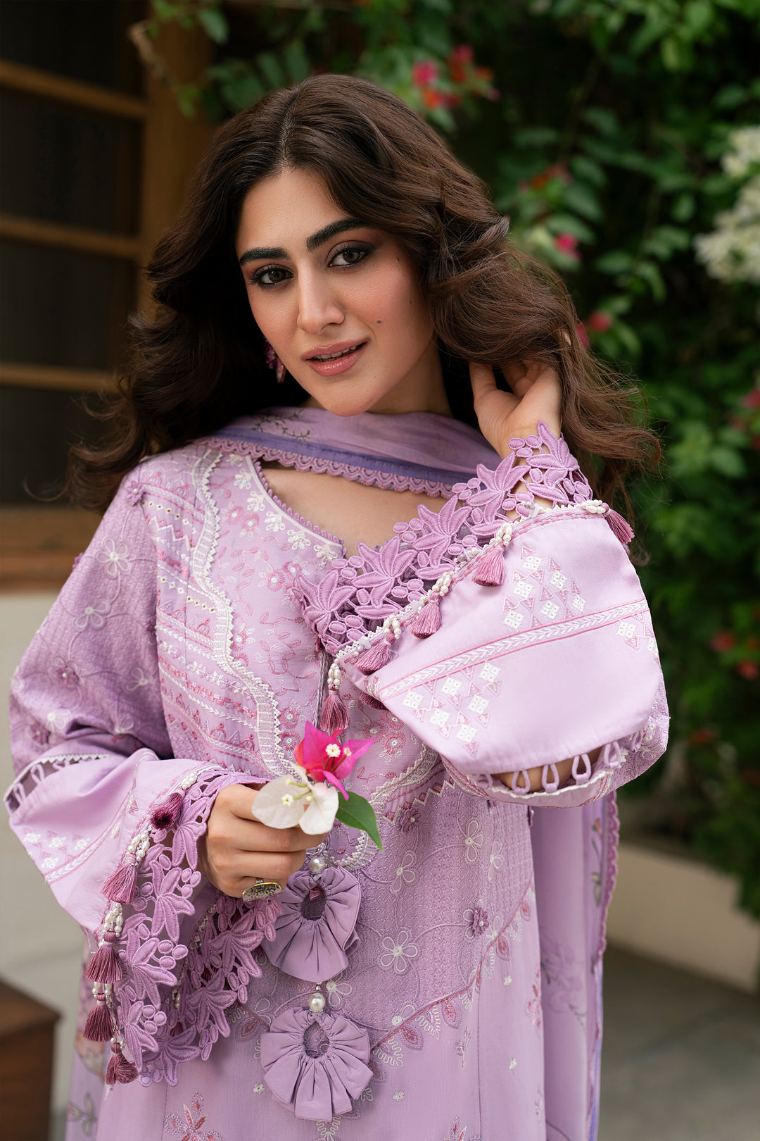 Close-up portrait of Izna lilac embroidered outfit highlighting tassel neckline, schiffli motifs and floral printed dupatta styling