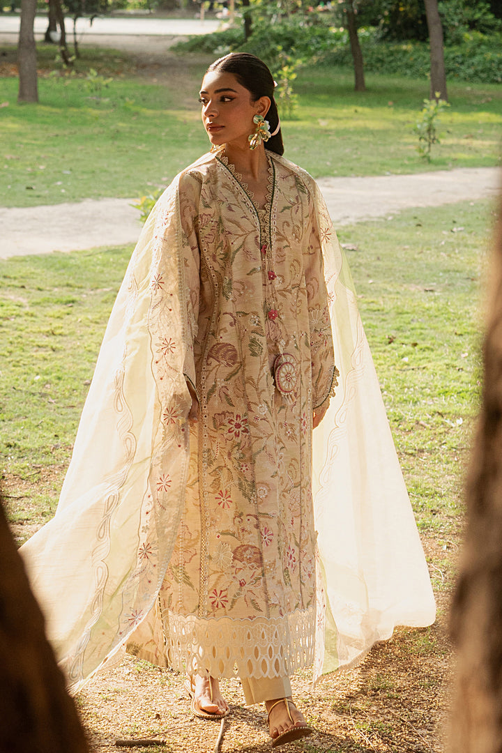 Side angle of Andalib skin lawn dress highlighting fitted sleeves, floral embroidery, tassel detail and lace finishing