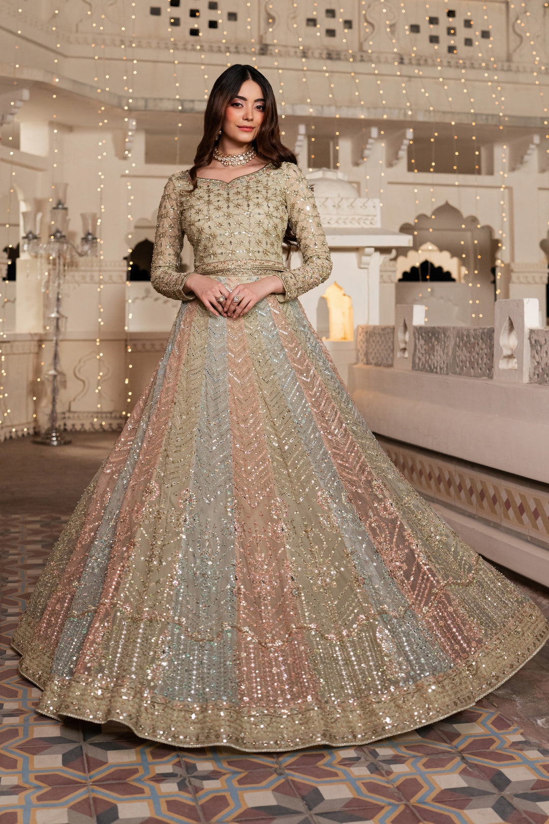 Woman in a traditional embroidered outfit standing in an ornate indoor setting.