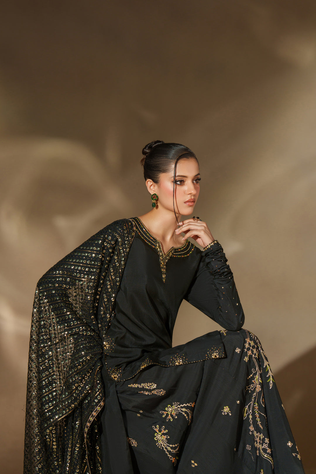 Styled look of NAQSHI Misam black sharara outfit with coordinated dupatta and traditional design perfect for events and festive occasions