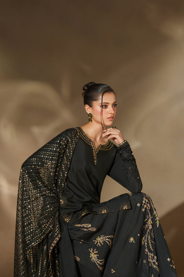 Styled look of NAQSHI Misam black sharara outfit with coordinated dupatta and traditional design perfect for events and festive occasions