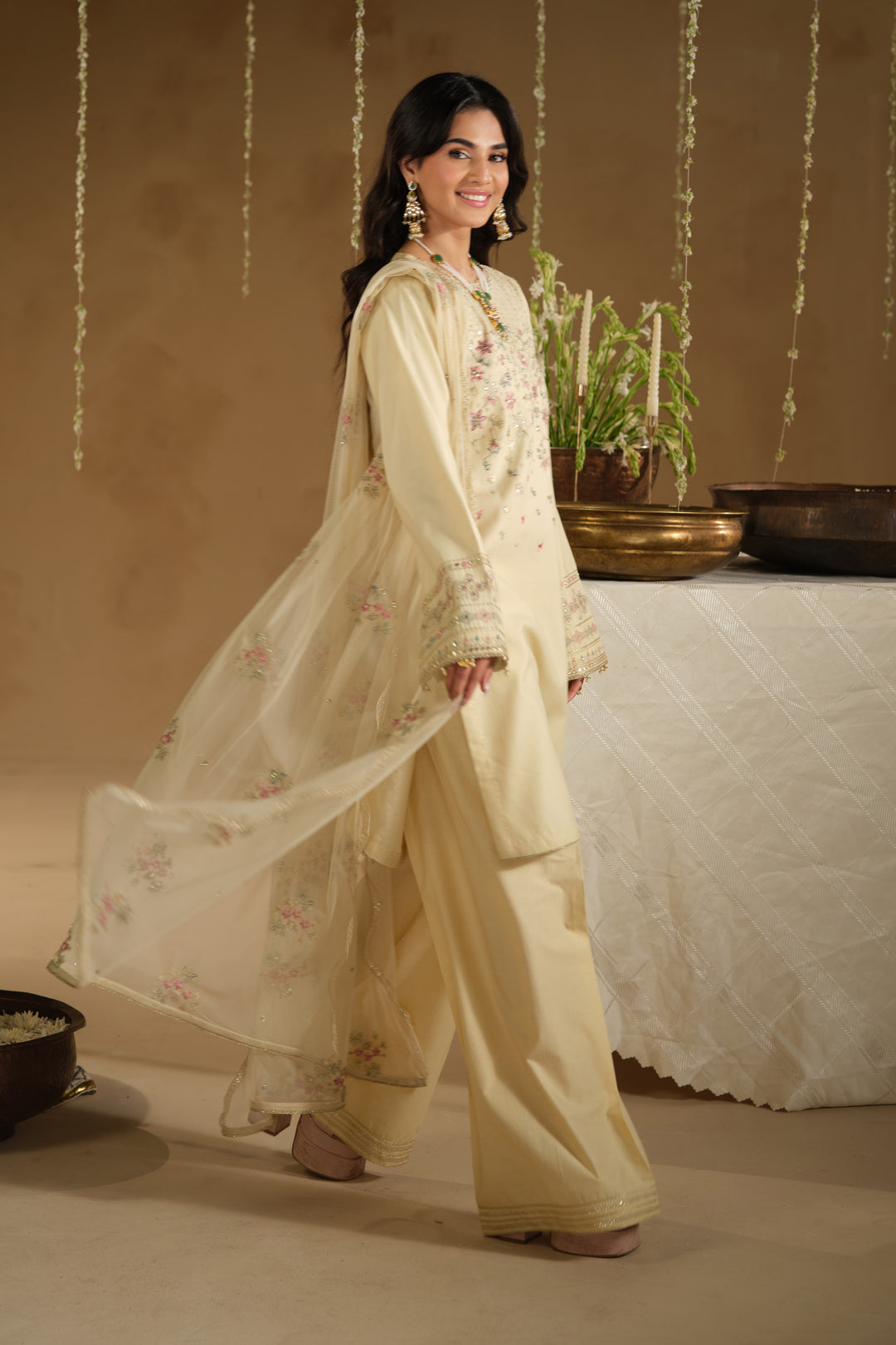Walking pose of Arosel Eid outfit with flowing net dupatta and soft festive styling
