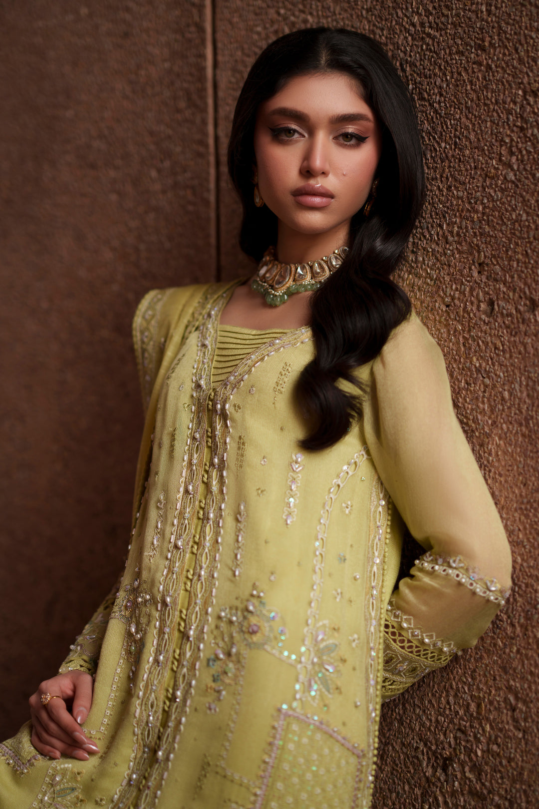Portrait styling shot of Pedro lime green embroidered evening wear outfit featuring detailed neckline, fitted sleeves and refined festive elegance