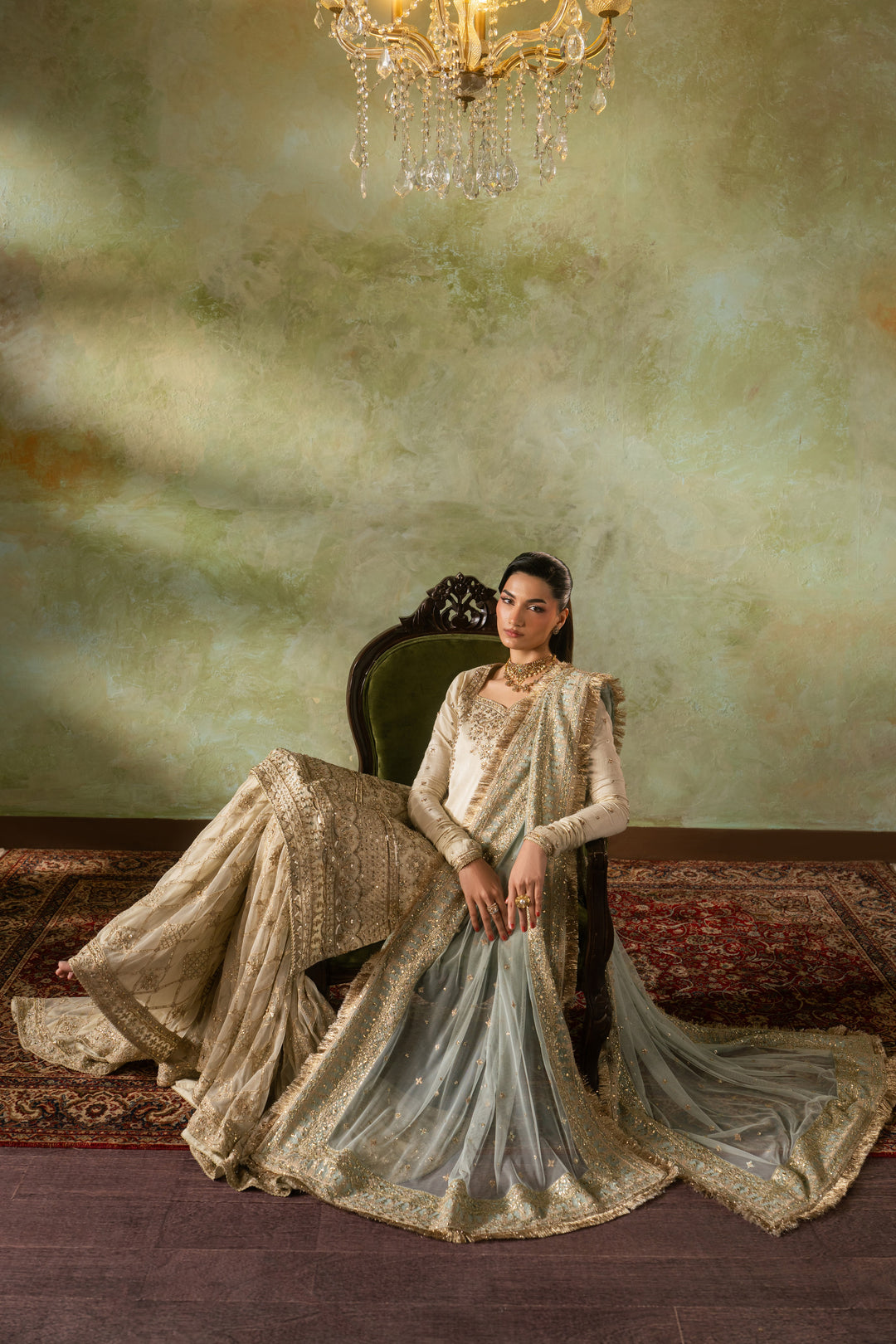Seated look of Zemira Nikkah outfit featuring wide spread farshi gharara and long dupatta trail, calm and elegant ready made wedding dress.