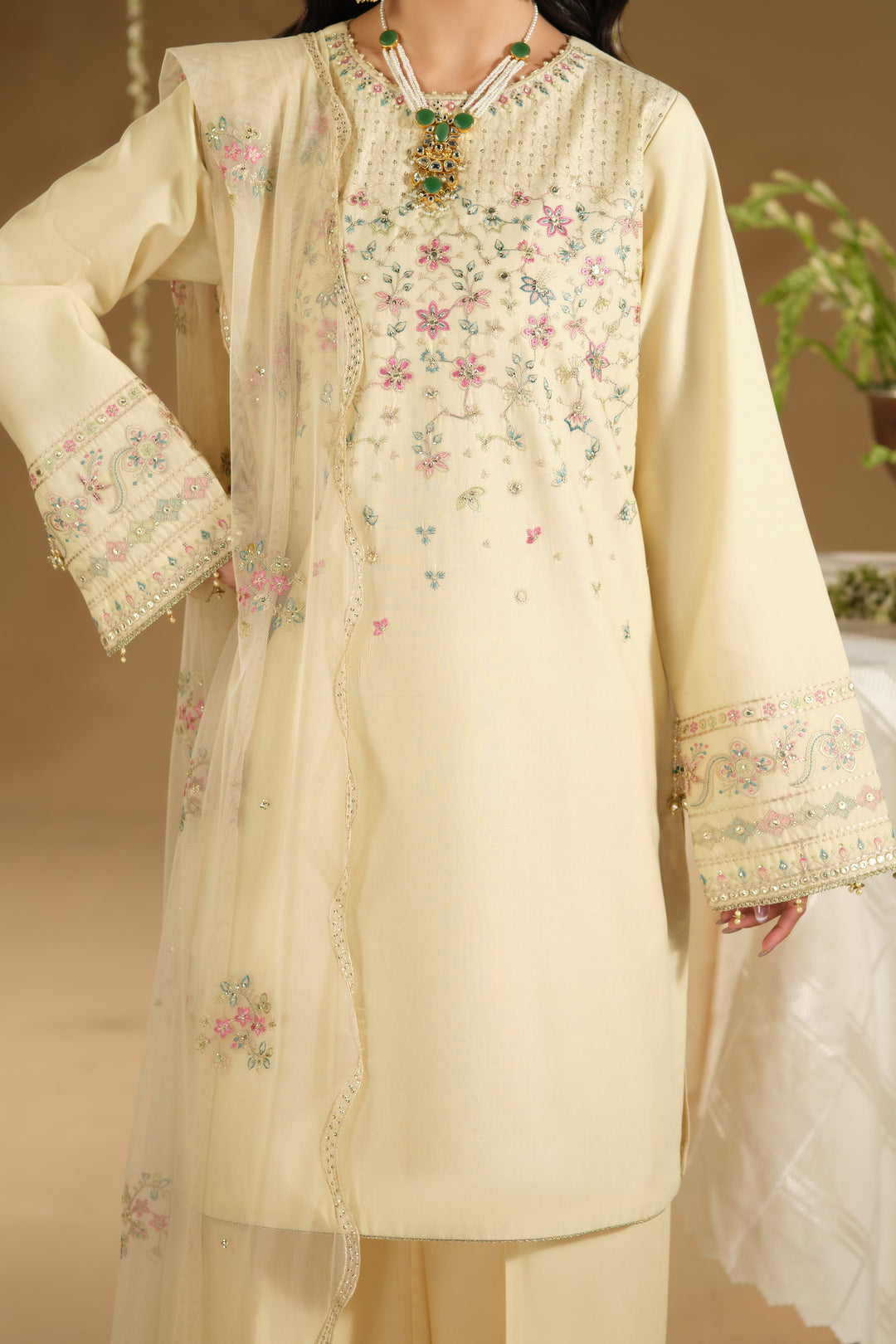 Close up of Arosel shirt jaal embroidery and neckline detailing on beige Pima lawn fabric