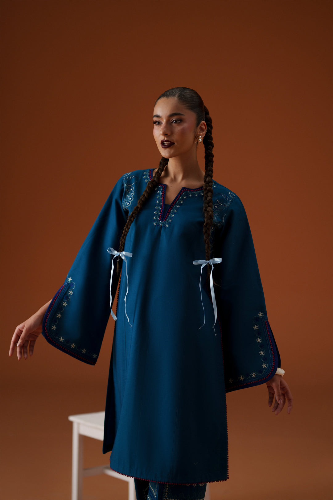 Front pose of Juni teal embroidered ready-to-wear outfit showing neckline detail, loose sleeves, and statement culotte embroidery.