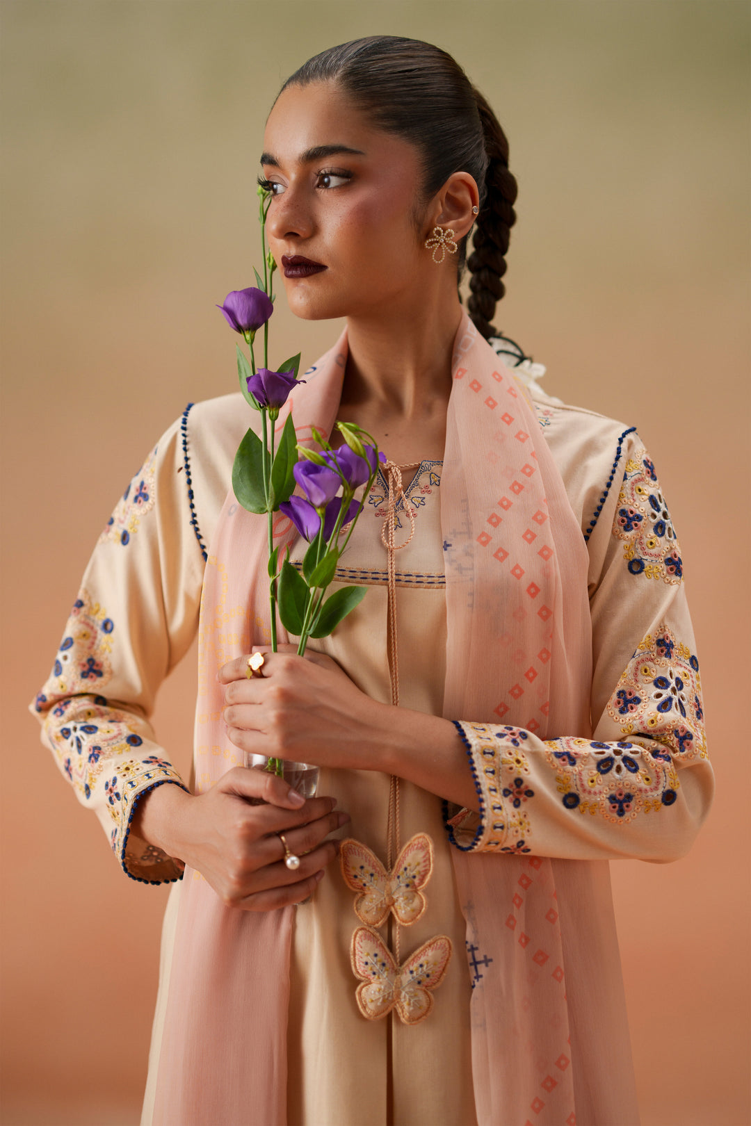 Close-up of Faye light peach embroidered neckline, tassel detail, quarter sleeves, and printed crinkle chiffon dupatta.