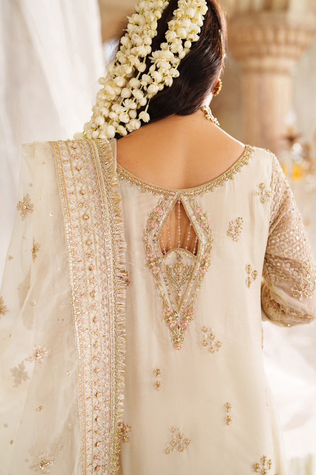 Back embroidery detail on NAQSHI Aneeqa ivory beige formal dress showing fine pattern work and designer finish for weddings.