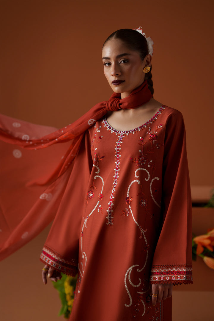 Close-up of Ophelia rust embroidered lawn shirt with lace sleeve detailing and printed crinkle chiffon dupatta for festive styling.