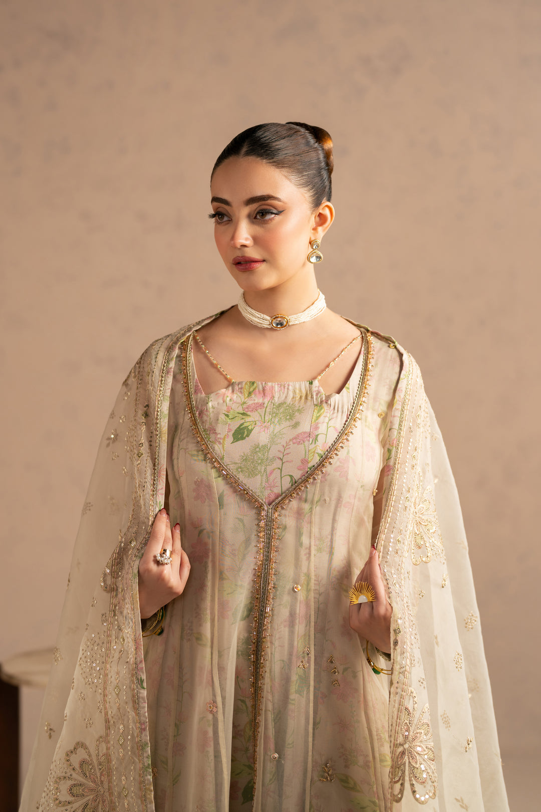 Upper body view focusing on front neckline embellishment and organza texture finish.