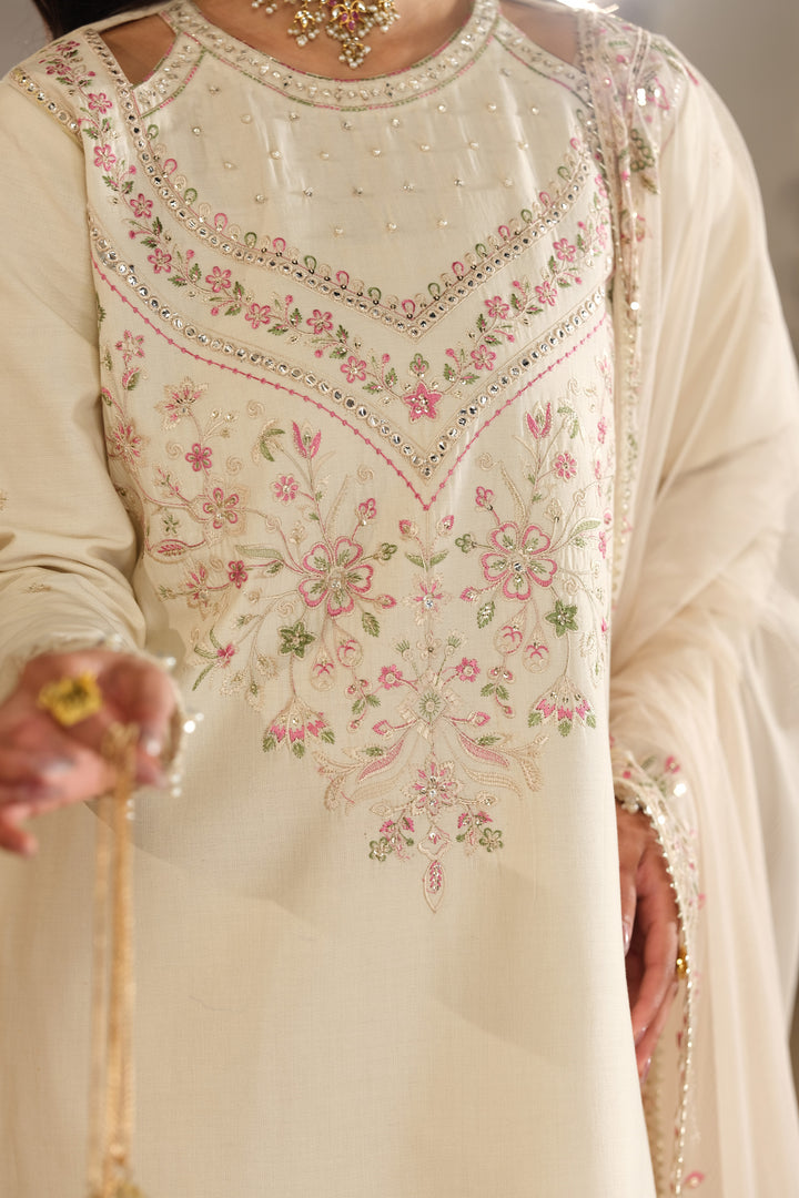 Close up embroidery detail of Rafza shirt neckline with soft pastel threadwork on skin beige Pima lawn fabric