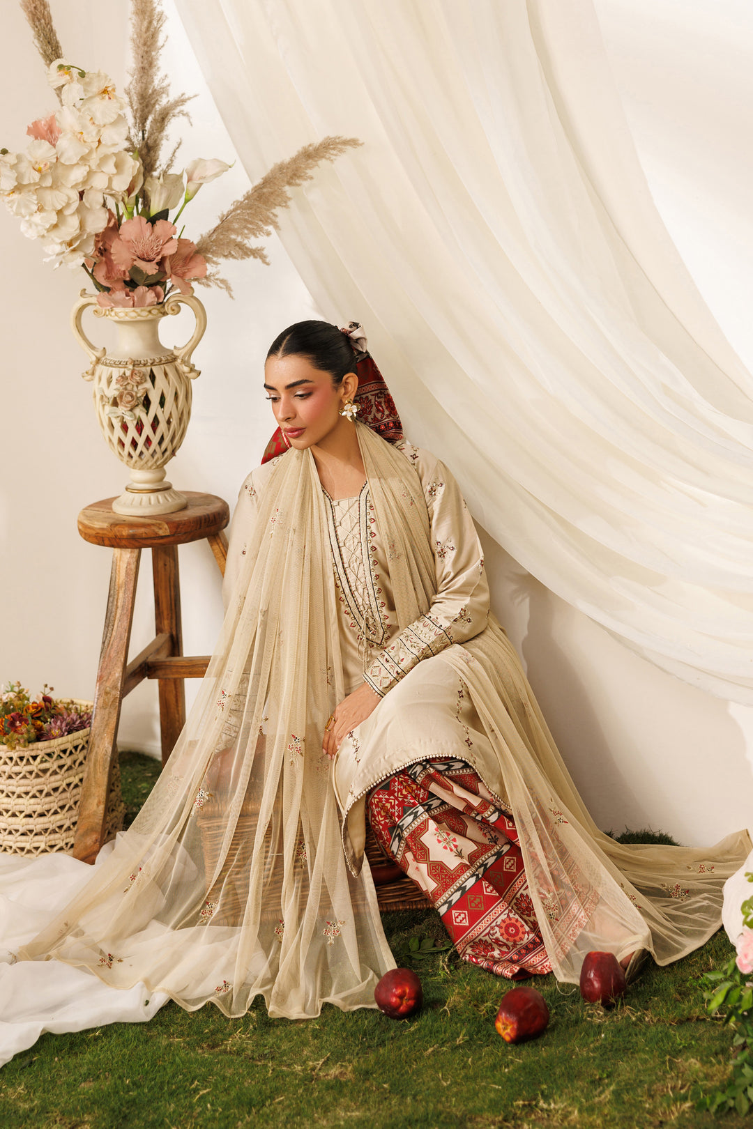Seated pose of NAQSHI Numa outfit showing flowing net dupatta, printed culottes, and soft casual styling