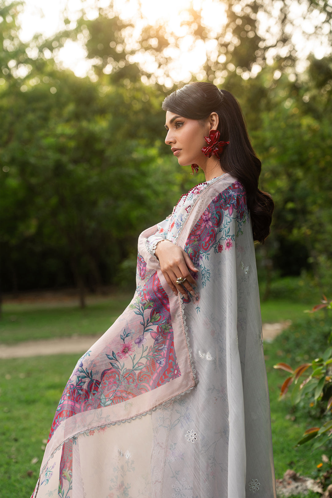 Side angle of Zimra grey lawn dress highlighting fitted sleeves, lace details, keyhole design and organza finishing