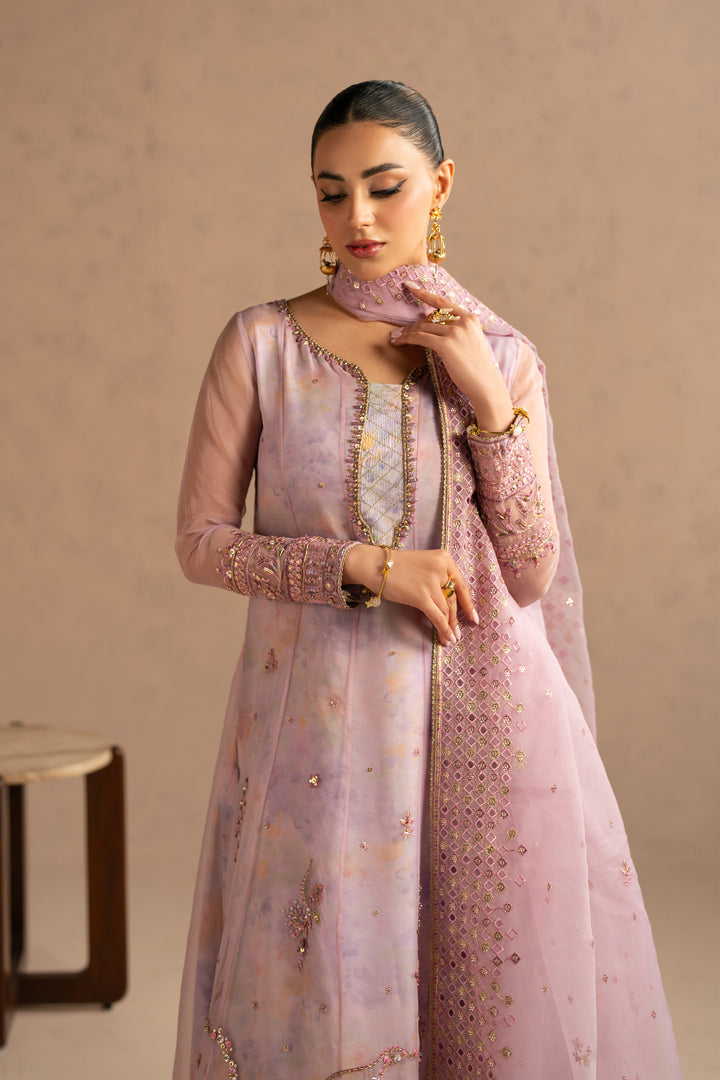 Portrait view focusing on neckline embellishment and soft mauve shade, graceful family function outfit.