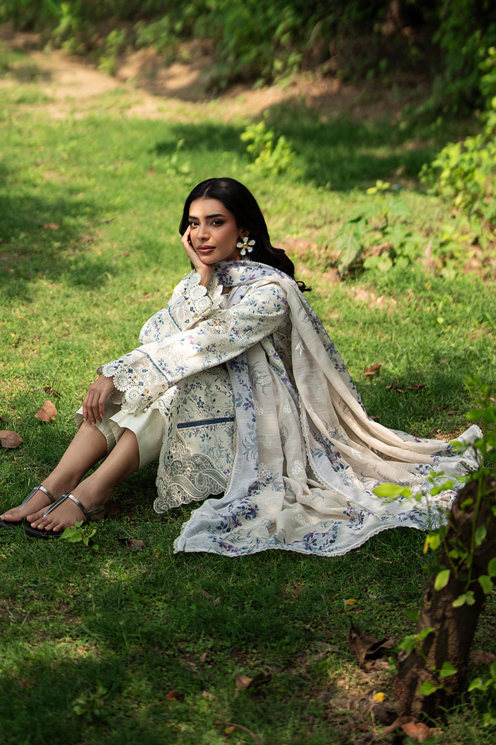 Sitting pose of Jaizah off white summer outfit showing straight cambric trouser and soft airy fabric for daytime wear
