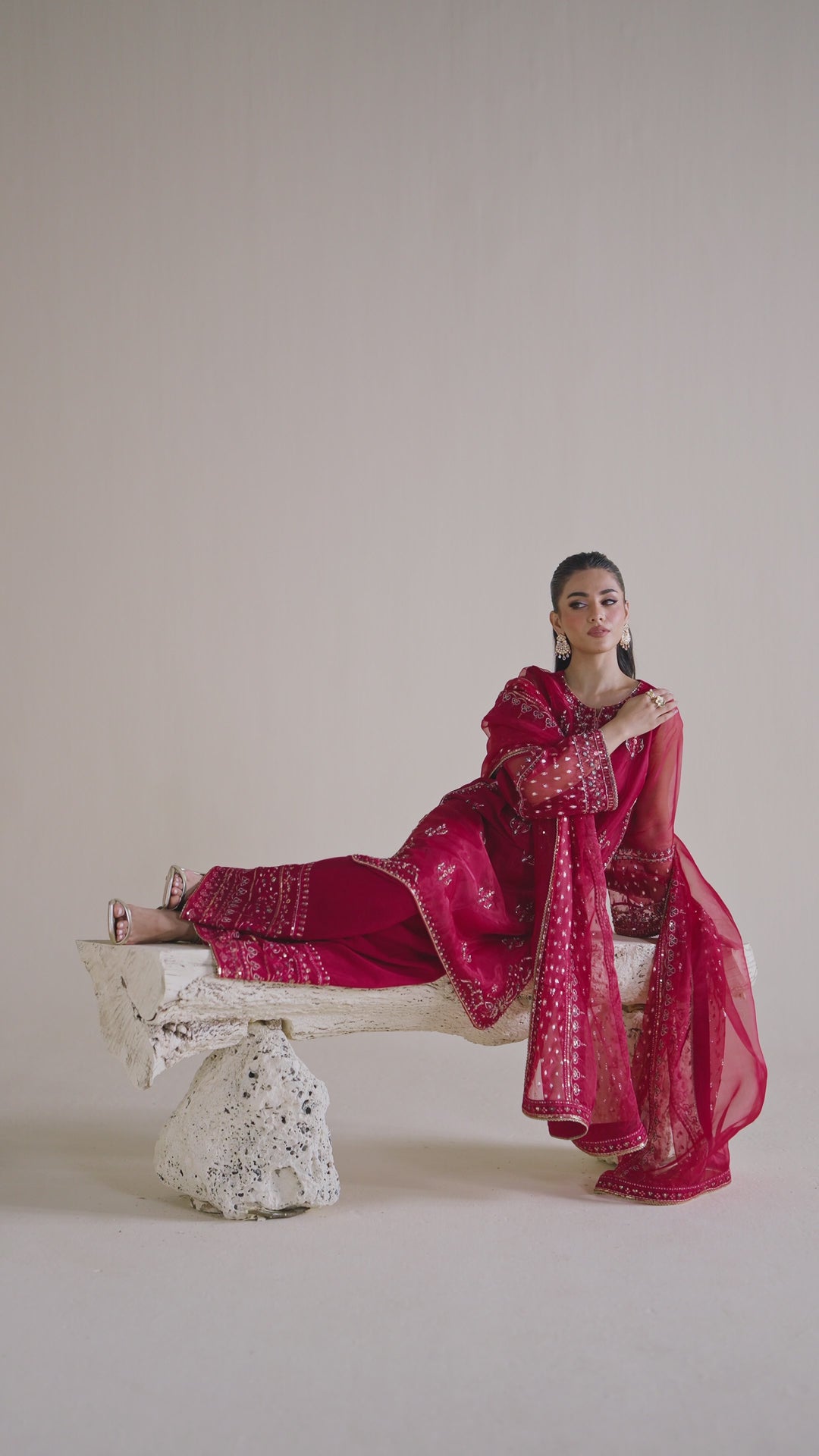 NAQSHI ready-to-wear deep red formal dress shown in motion, displaying smooth fabric flow and complete event outfit