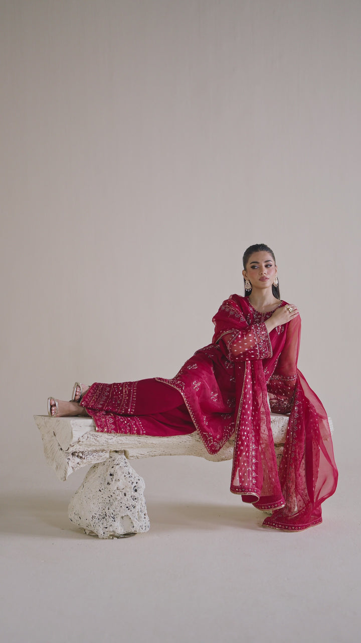 NAQSHI ready-to-wear deep red formal dress shown in motion, displaying smooth fabric flow and complete event outfit