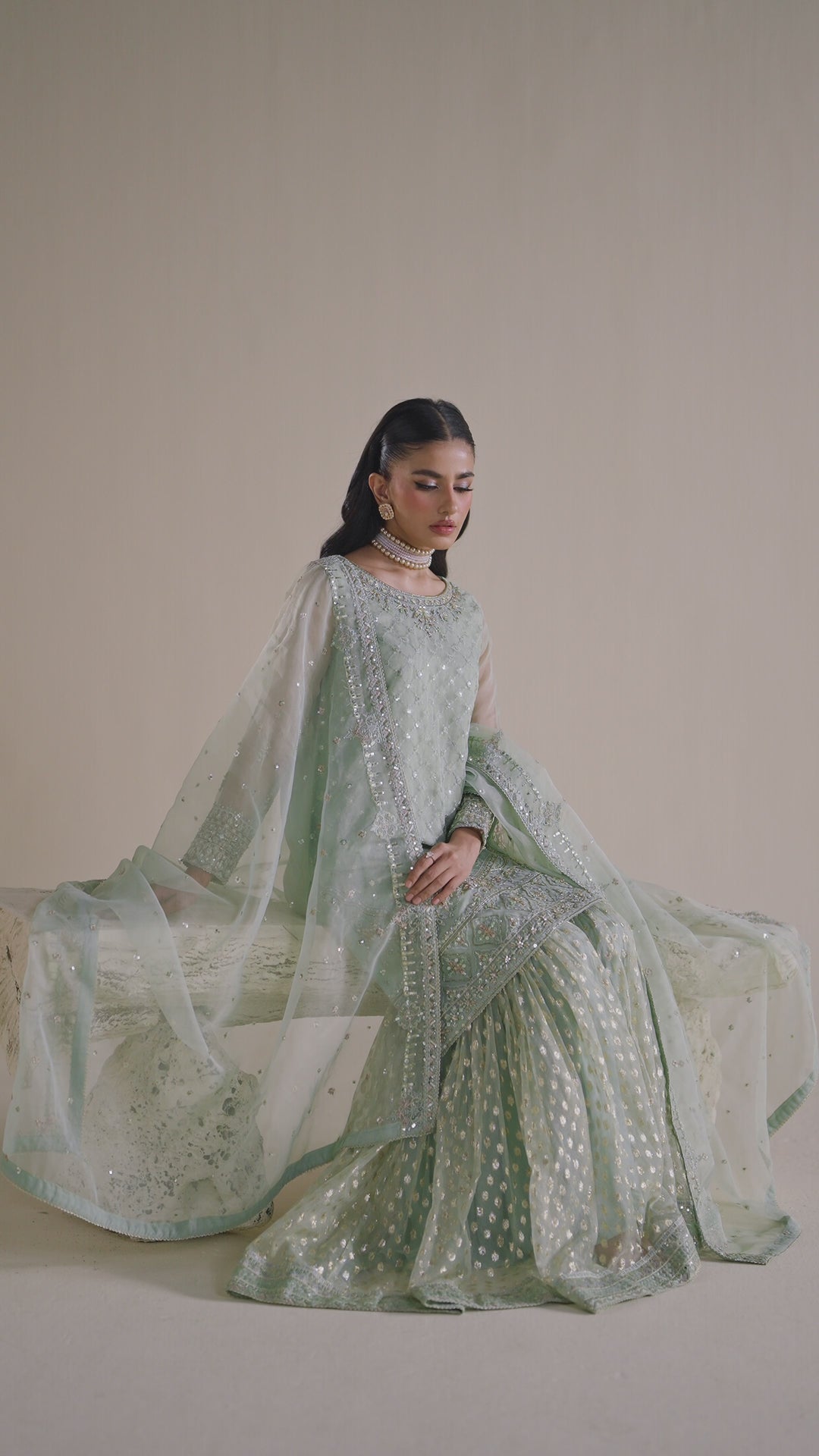 NAQSHI sage green dress shown in motion, highlighting elegant flow and polished event look
