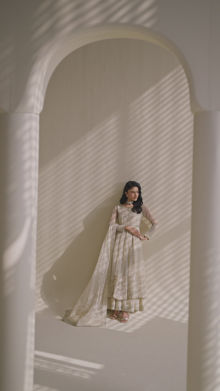 Tall shot of NAQSHI Aroha off-white organza and raw-silk dress with flowing silhouette — semi-formal ready-to-wear outfit for parties and events
