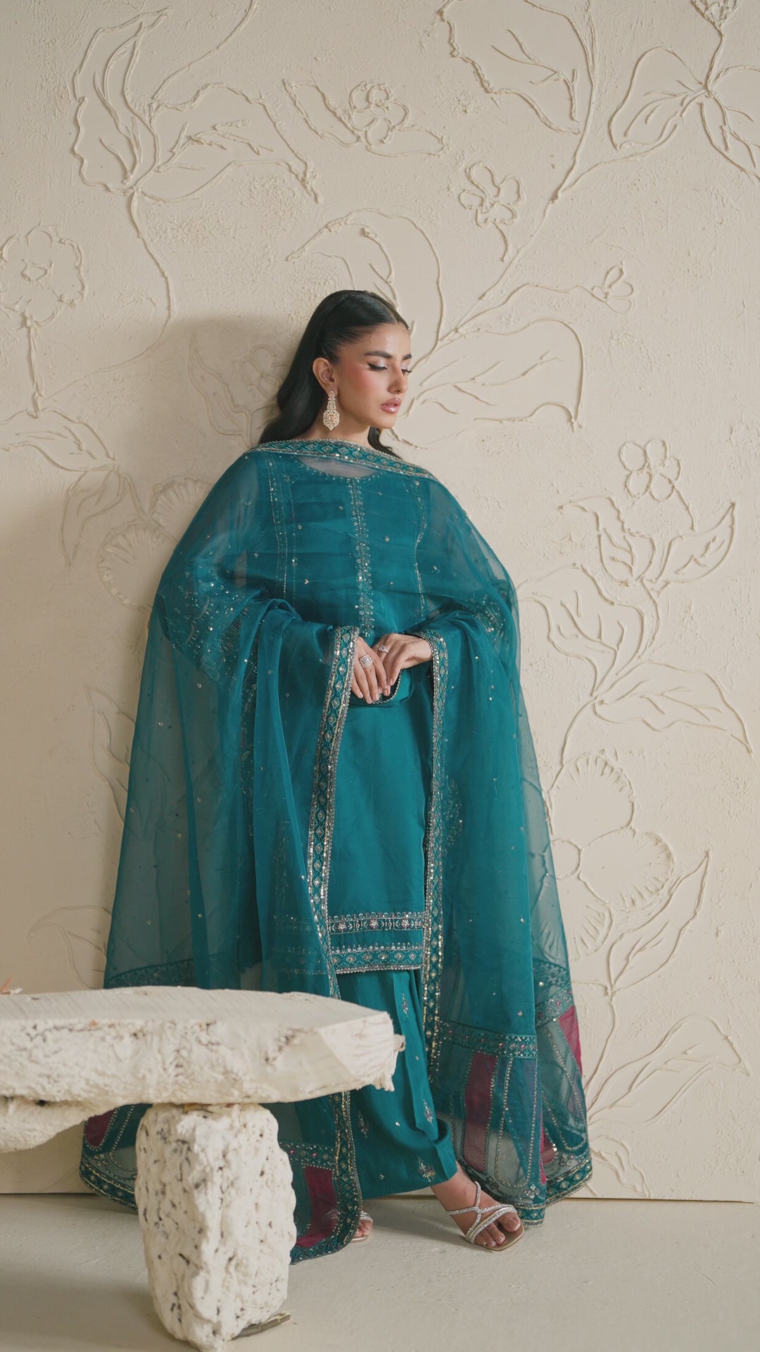 NAQSHI deep teal dress shown in motion, highlighting soft fabric movement and graceful event styling