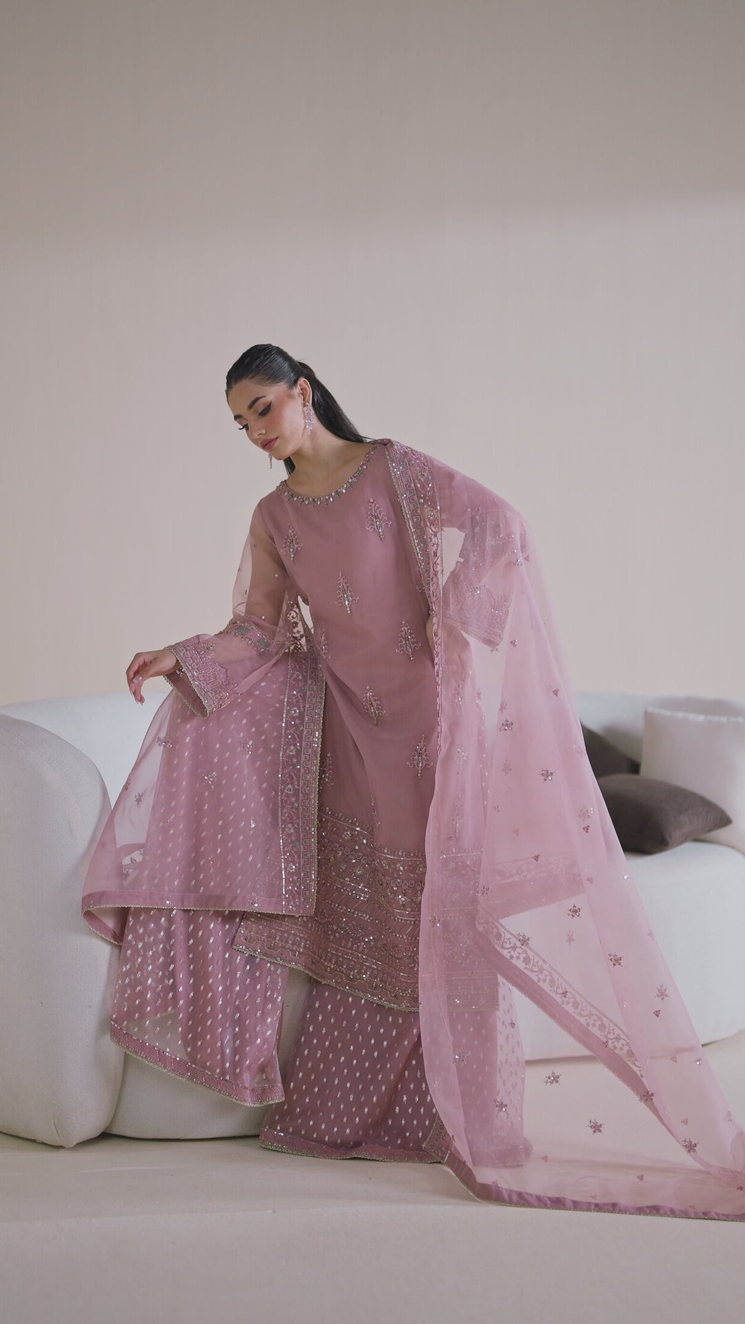 NAQSHI ready-to-wear blush pink formal dress shown in motion, displaying smooth fabric flow and complete event-ready design