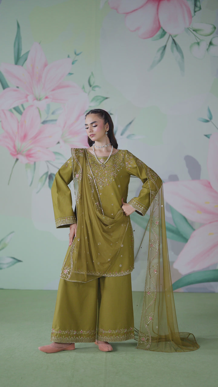 Model wearing NAQSHI Radha 3‑piece dark olive ensemble with shirt, culottes, and dupatta

